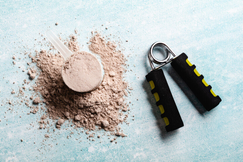 Scoops filled with protein powders for fitness nutrition to start training