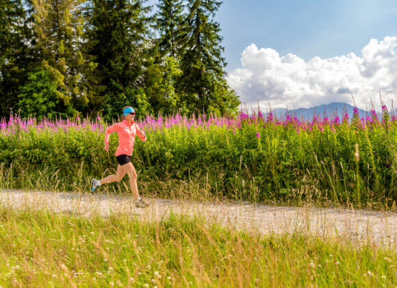 Woman athlete trail running in mountains, sport and fitness