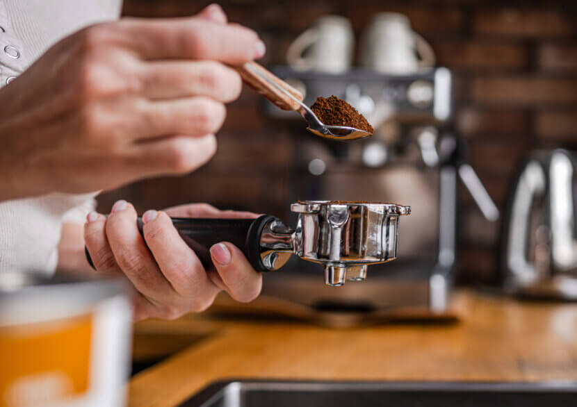Woman Is Pouring Coffee Into Espresso Machine Portafilter